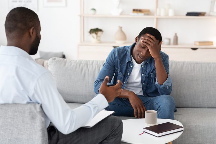 Psychotherapy Concept. Depressed man talking to psychologist during individual therapy