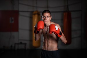 Young teenager kick boxer in the gym